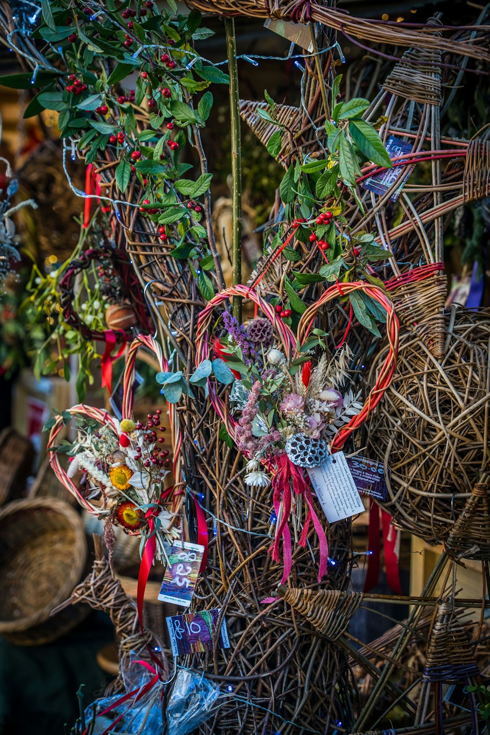 Handcrafted willow wreaths, stars, and dried flower bouquets with fairy lights.