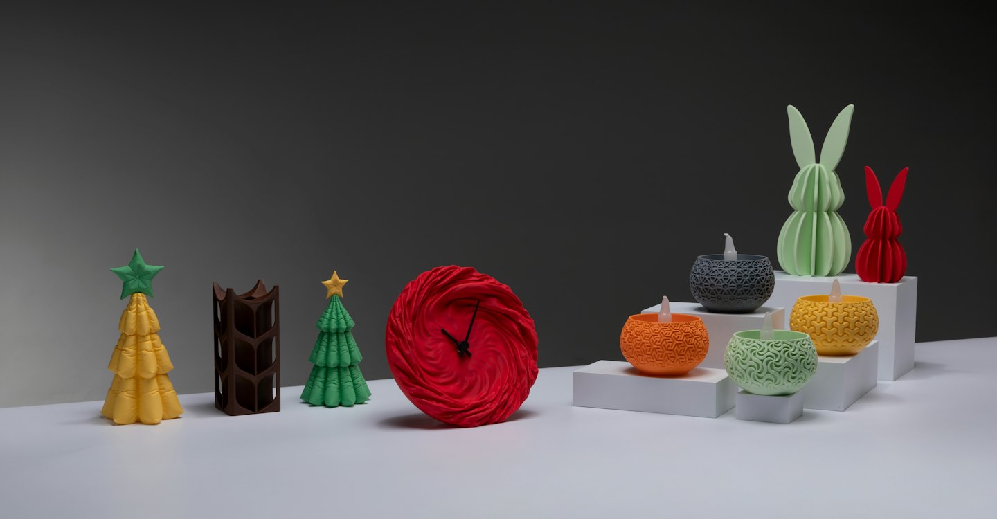 Colorful 3D printed decorative objects arranged on a white surface.